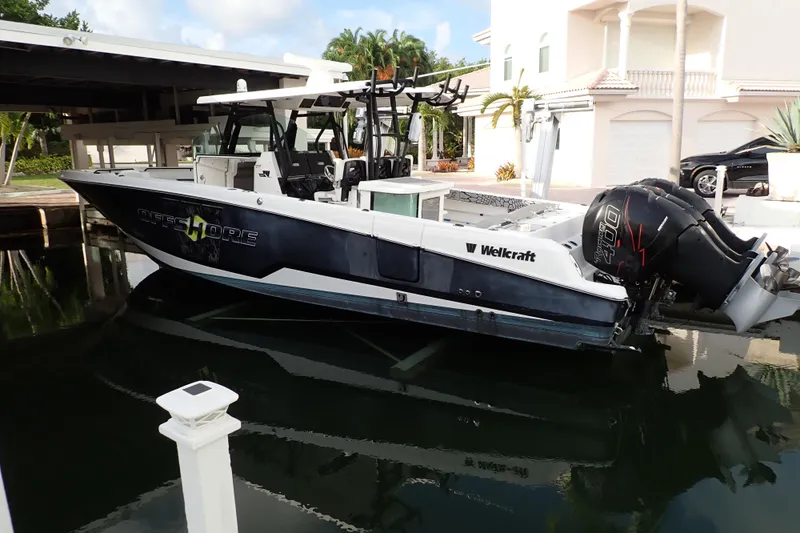  Yacht Photos Pics 2019 Wellcraft 352 Fisherman boat docked near waterfront home.