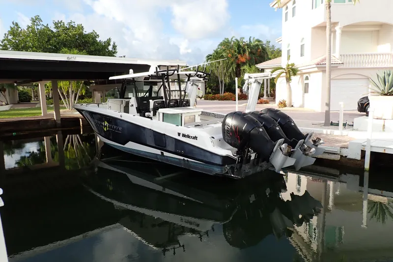  Yacht Photos Pics 2019 Wellcraft 352 Fisherman boat docked in a serene waterfront setting.
