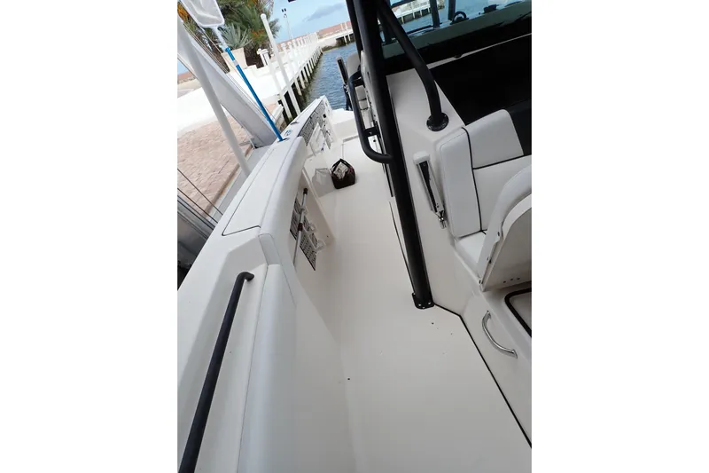  Yacht Photos Pics 2019 Wellcraft 352 Fisherman boat interior with seating and railing, docked by the water.