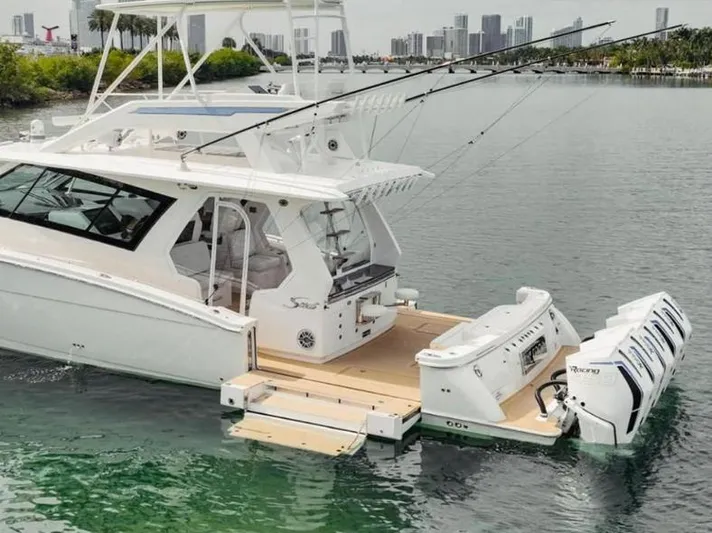 Scout 530 Lxf Yacht Photos Pics 2021 Scout 530 LXF luxury boat with multiple engines docked in a scenic marina.