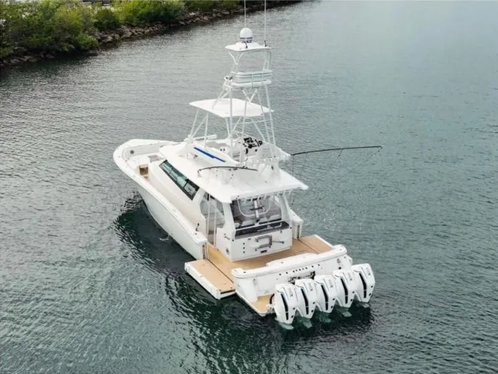 Scout 530 Lxf Yacht Photos Pics 2021 Scout 530 LXF boat with multiple engines on calm water.