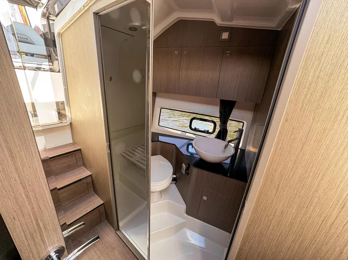  Yacht Photos Pics 2024 Beneteau Flyer 10 interior bathroom with modern fixtures and wooden cabinetry.