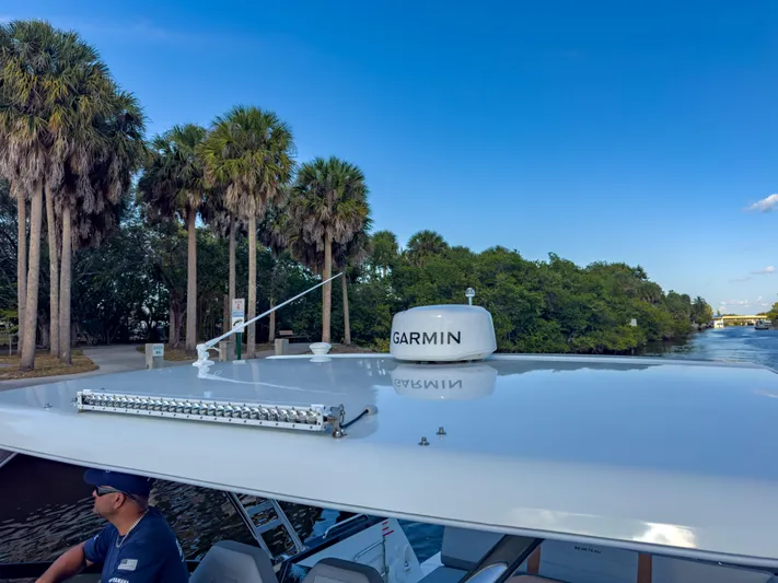  Yacht Photos Pics 2024 Beneteau Flyer 10 boat with Garmin equipment, near palm trees and waterway.