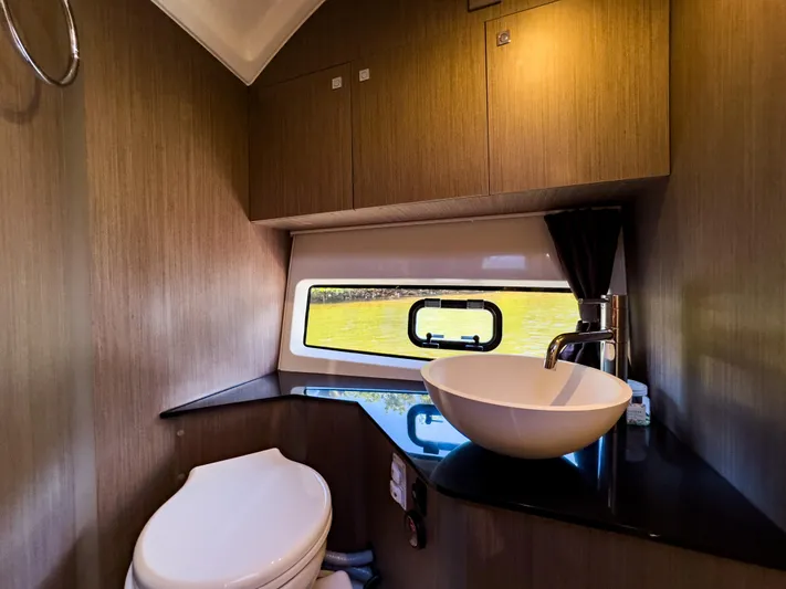  Yacht Photos Pics 2024 Beneteau Flyer 10 bathroom with modern sink, toilet, and window view.