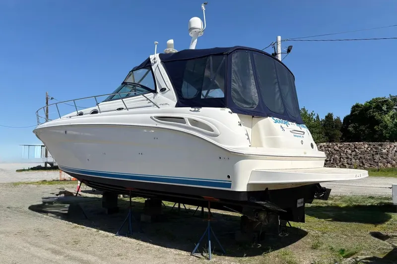  Yacht Photos Pics 2003 Sea Ray 380 Sundancer yacht on land, blue sky background.