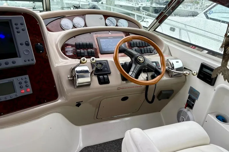  Yacht Photos Pics Helm of 2003 Sea Ray 380 Sundancer with wooden steering wheel and control panel.