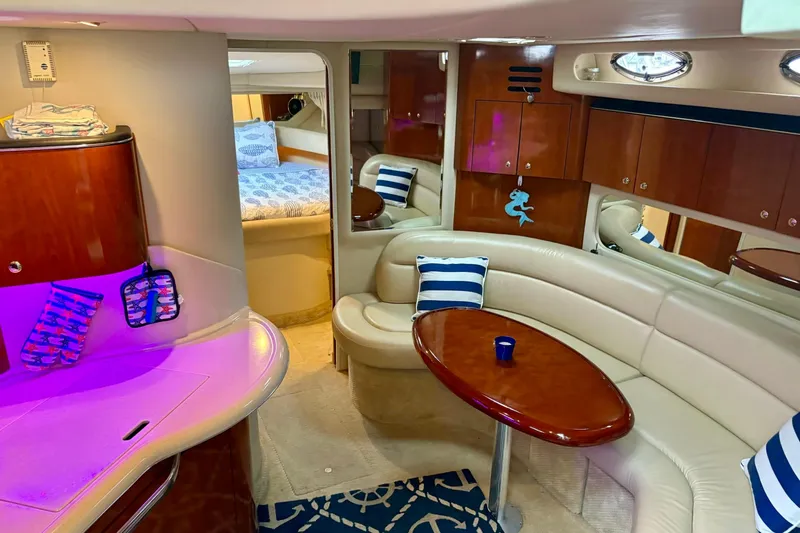  Yacht Photos Pics Luxurious interior of 2003 Sea Ray 380 Sundancer yacht with cozy seating and elegant decor.