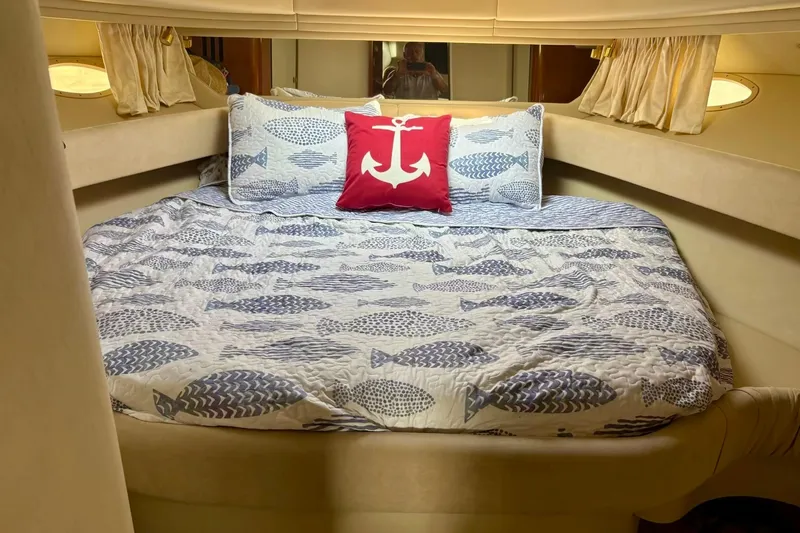  Yacht Photos Pics Cozy cabin interior of 2003 Sea Ray 380 Sundancer with nautical-themed bedding.