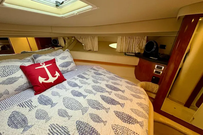  Yacht Photos Pics Luxurious cabin interior of 2003 Sea Ray 380 Sundancer with nautical-themed bedding.