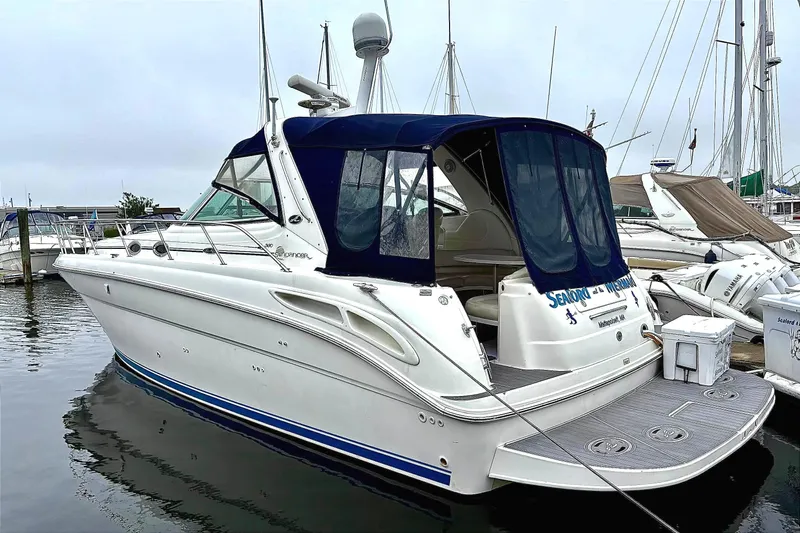  Yacht Photos Pics 2003 Sea Ray 380 Sundancer yacht docked at marina, featuring sleek design and blue canopy.