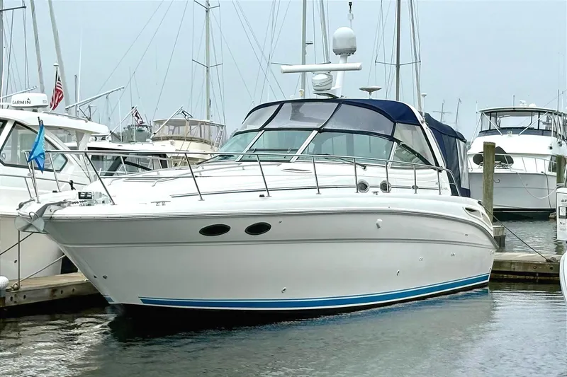  Yacht Photos Pics 2003 Sea Ray 380 Sundancer docked at marina, surrounded by other boats.