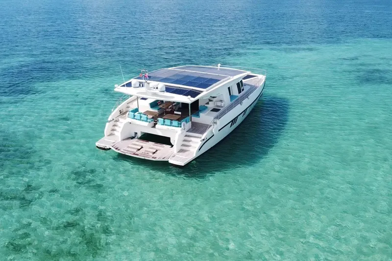 Firefly Yacht Photos Pics Luxurious 2018 Serenity 64 yacht with solar panels on turquoise water.