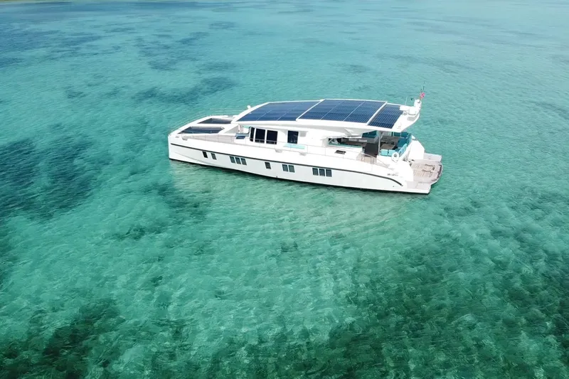 Firefly Yacht Photos Pics Solar-powered Serenity 64 yacht from 2018 on clear turquoise waters.
