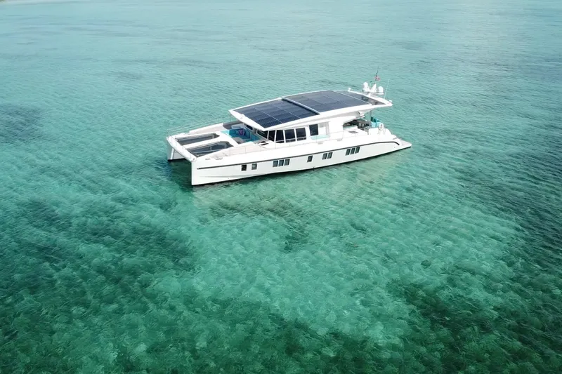 Firefly Yacht Photos Pics Solar-powered Serenity 64 yacht from 2018 on clear turquoise waters.