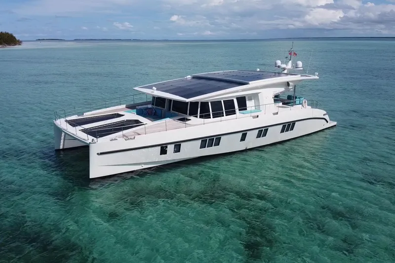 Firefly Yacht Photos Pics Luxurious 2018 Serenity 64 yacht on clear turquoise waters, featuring sleek design and solar panels.