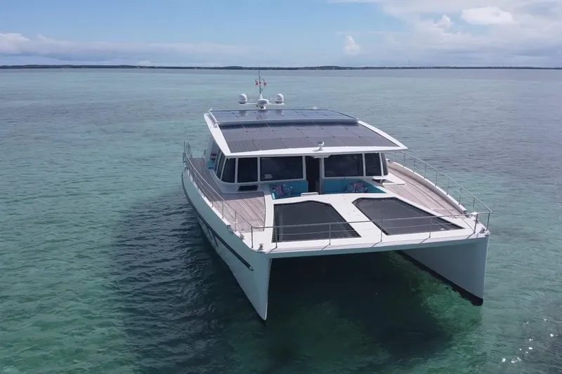 Firefly Yacht Photos Pics 2018 Serenity 64 yacht with solar panels on calm ocean waters.