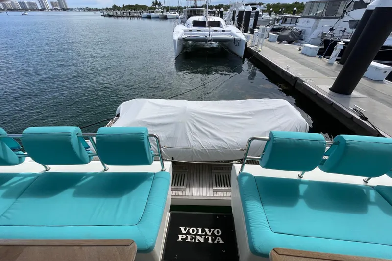 Firefly Yacht Photos Pics Luxurious Serenity 64 yacht with turquoise seating, docked at marina, 2018 model.