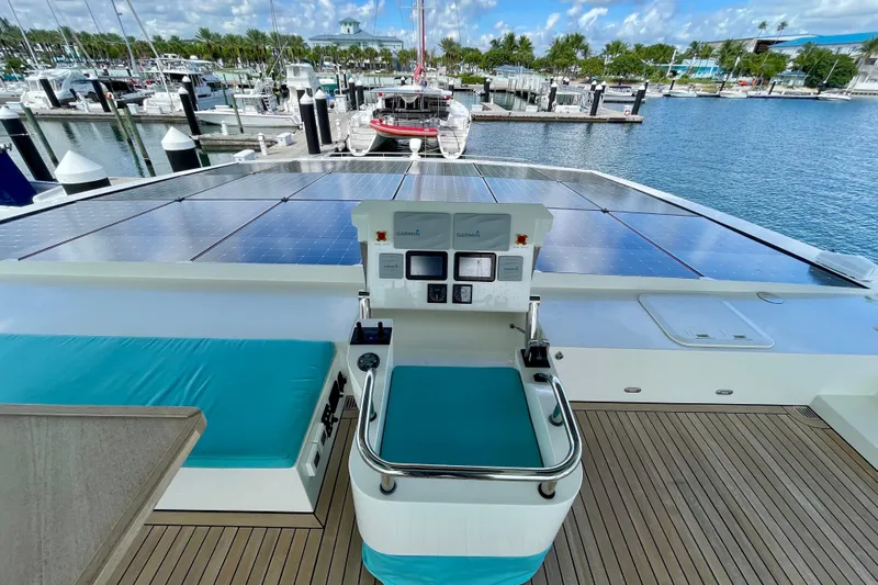 Firefly Yacht Photos Pics Luxurious Serenity 64 yacht deck with solar panels, marina view, and modern controls, 2018 model.