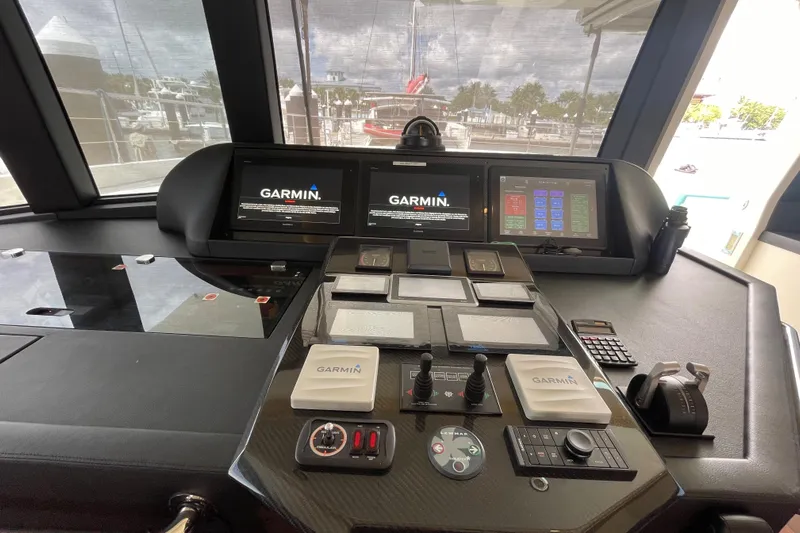 Firefly Yacht Photos Pics Control panel of a 2018 Serenity 64 yacht with Garmin navigation displays.