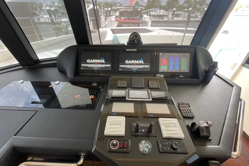 Firefly Yacht Photos Pics Cockpit of 2018 Serenity 64 yacht with Garmin navigation displays and control panels.
