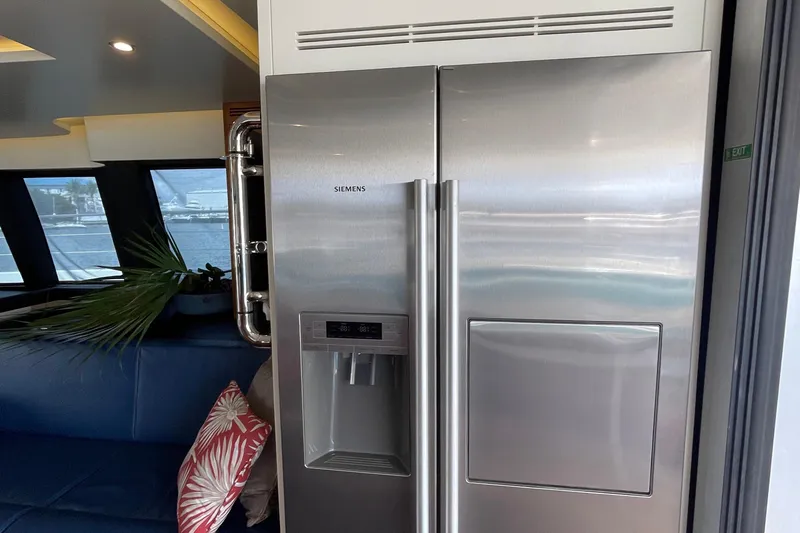 Firefly Yacht Photos Pics Stainless steel Siemens refrigerator on Serenity 64 yacht, 2018 model, with modern interior design.