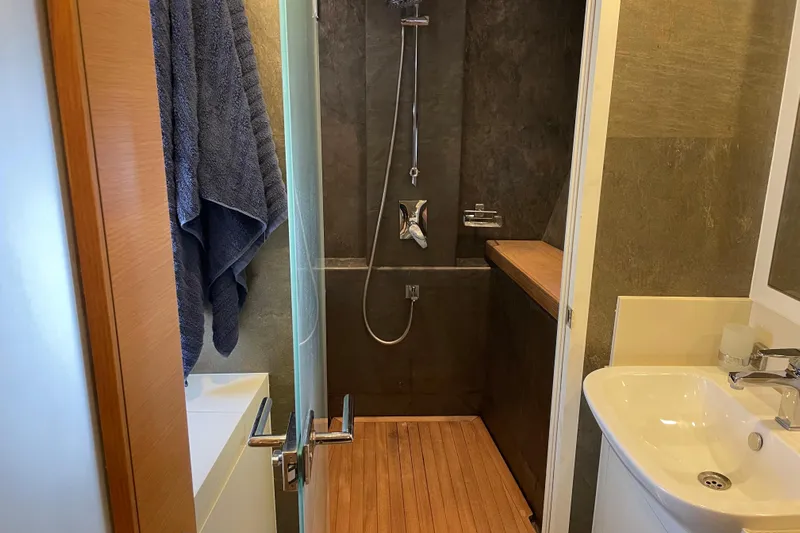Firefly Yacht Photos Pics Modern bathroom in 2018 Serenity 64 yacht with sleek shower and wooden flooring.