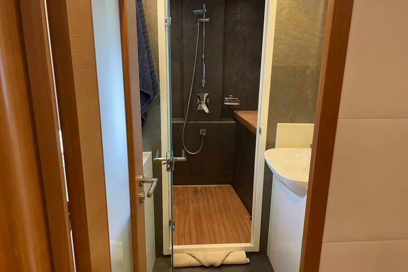 Firefly Yacht Photos Pics Compact modern bathroom with wooden accents in a 2018 Serenity 64 model.