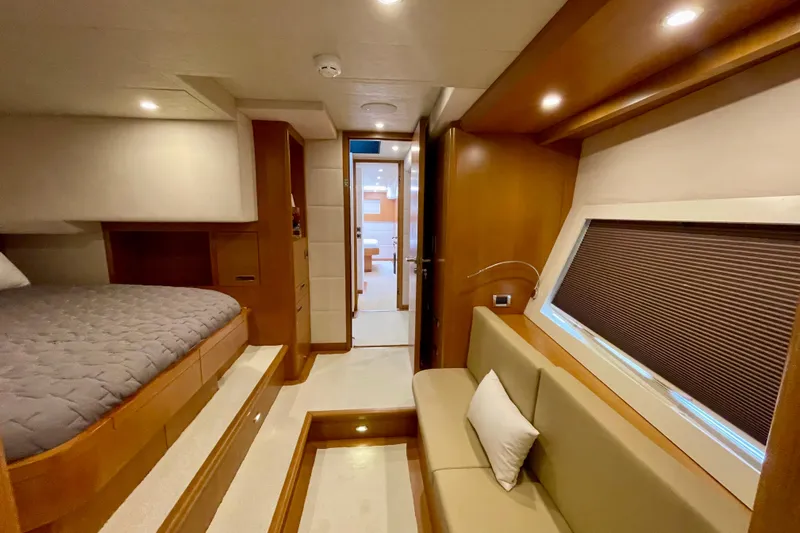 Firefly Yacht Photos Pics Luxurious interior of 2018 Serenity 64 yacht with cozy bedroom and seating area.
