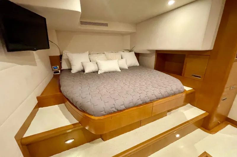 Firefly Yacht Photos Pics Luxurious bedroom interior of 2018 Serenity 64 yacht with cozy bedding and modern design.