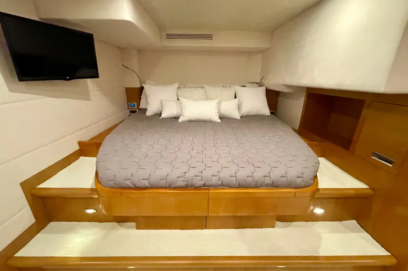 Firefly Yacht Photos Pics Luxurious bedroom in 2018 Serenity 64 yacht with cozy bedding and wall-mounted TV.
