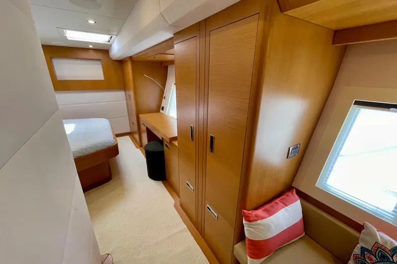 Firefly Yacht Photos Pics Luxurious 2018 Serenity 64 yacht cabin with modern wood interior and cozy seating.