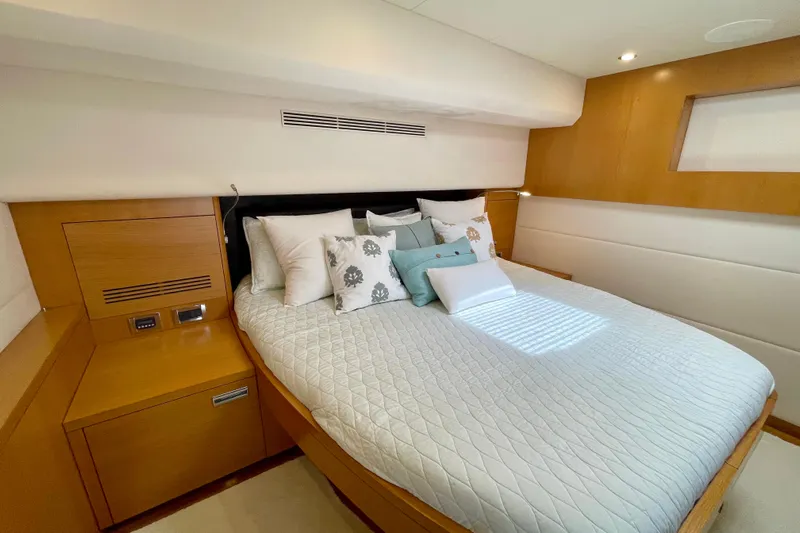Firefly Yacht Photos Pics Luxurious Serenity 64 yacht bedroom interior, 2018 model, featuring elegant bedding and wood accents.