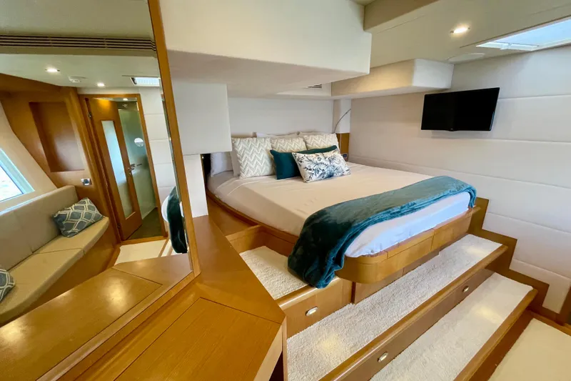 Firefly Yacht Photos Pics Luxurious bedroom interior of 2018 Serenity 64 yacht with elegant bedding and modern decor.