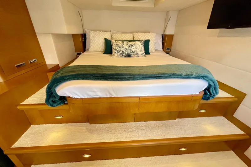 Firefly Yacht Photos Pics Luxurious Serenity 64 yacht bedroom with elegant bedding and wooden accents, 2018 model.