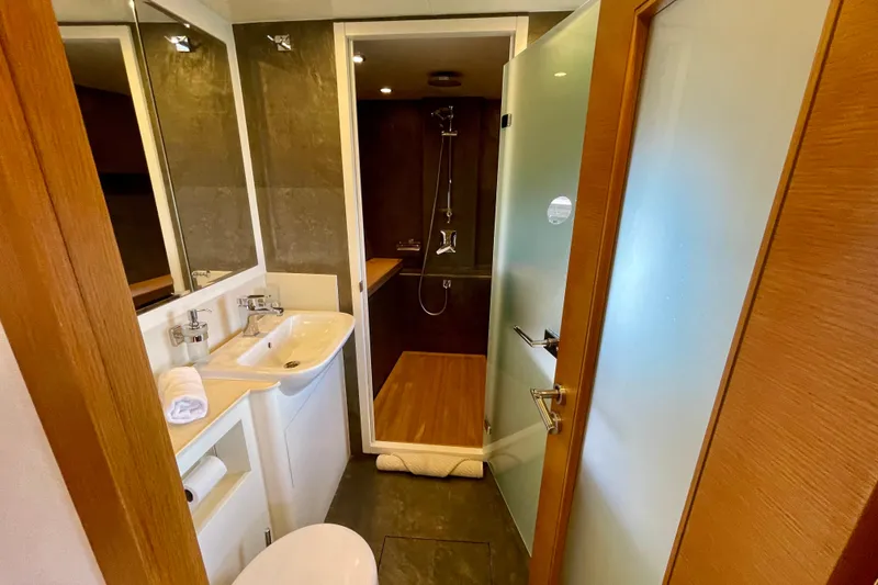 Firefly Yacht Photos Pics Modern bathroom in 2018 Serenity 64 yacht, featuring sleek design and wooden accents.