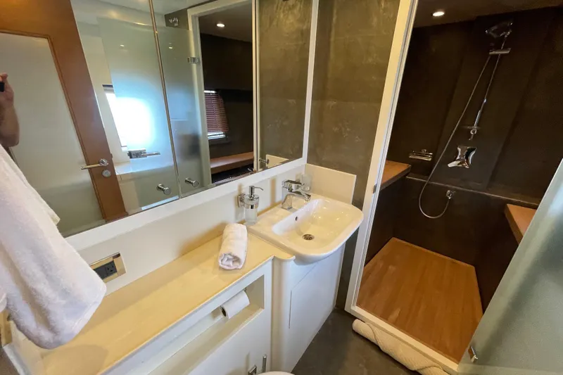 Firefly Yacht Photos Pics Luxurious bathroom in 2018 Serenity 64 yacht with modern fixtures and spacious shower.