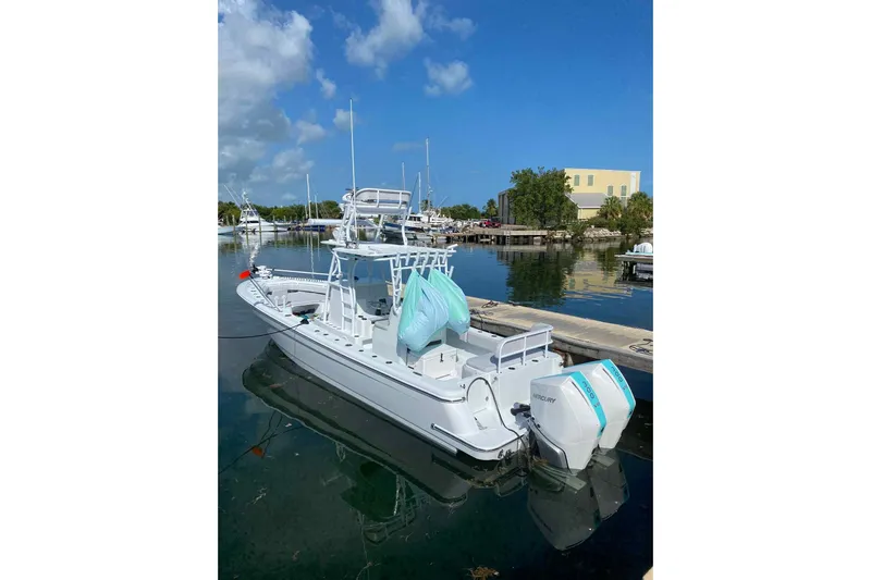 El Viaje Yacht Photos Pics 2023 Andros Offshore 32 boat docked in a marina under a clear blue sky.