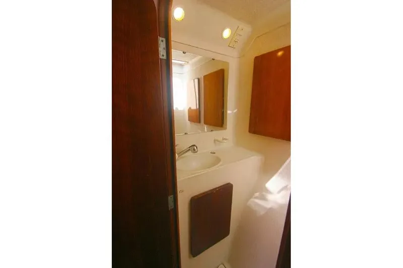 Scout Yacht Photos Pics Bathroom interior of 1992 Privilege 482 yacht with sink and wooden cabinets.