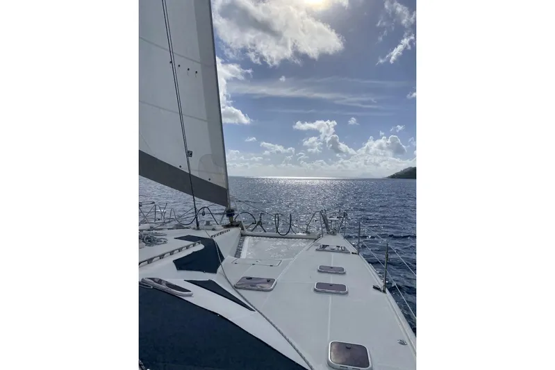 Scout Yacht Photos Pics Sailing on a 1992 Privilege 482 catamaran under a sunny sky, ocean view.