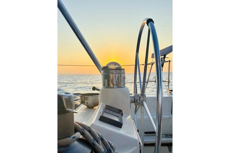 Scout Yacht Photos Pics Sailing yacht Privilege 482, 1992 model, steering wheel at sunset on open sea.