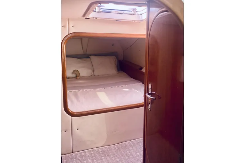 Scout Yacht Photos Pics Cozy cabin interior of 1992 Privilege 482 yacht with wooden door and bedding.