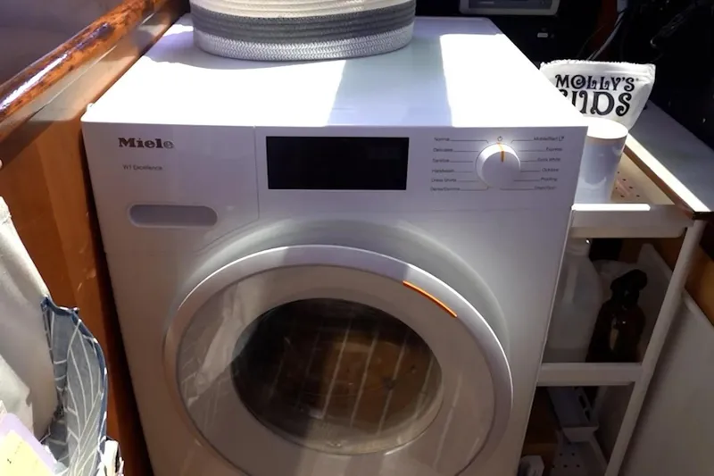 Scout Yacht Photos Pics A Miele washing machine in a cozy laundry space, with a Privilege 482 model from 1992 nearby.