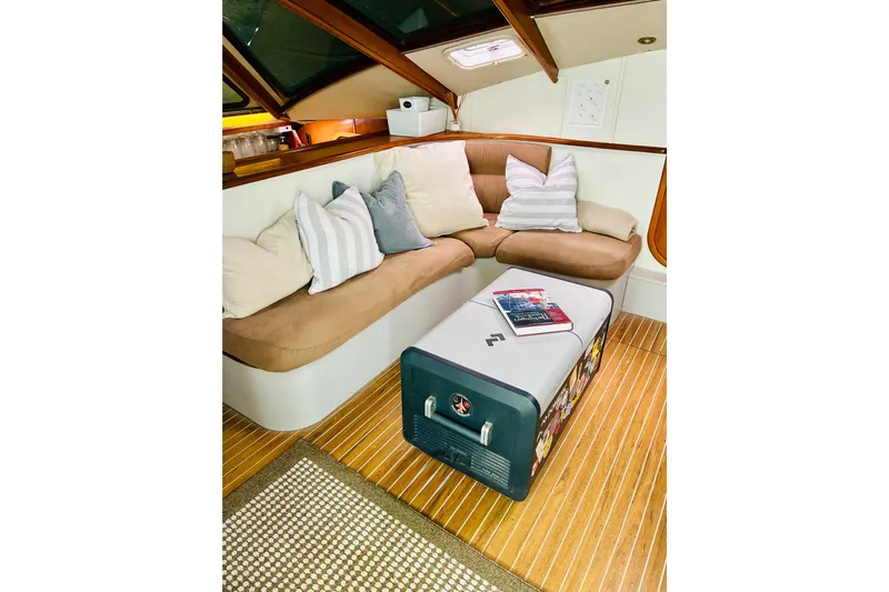Scout Yacht Photos Pics Cozy interior of 1992 Privilege 482 yacht with cushioned seating and wooden flooring.
