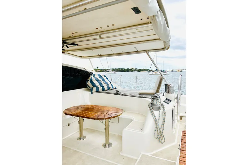 Scout Yacht Photos Pics Luxury Privilege 482 yacht deck with seating, table, and ocean view, 1992 model.