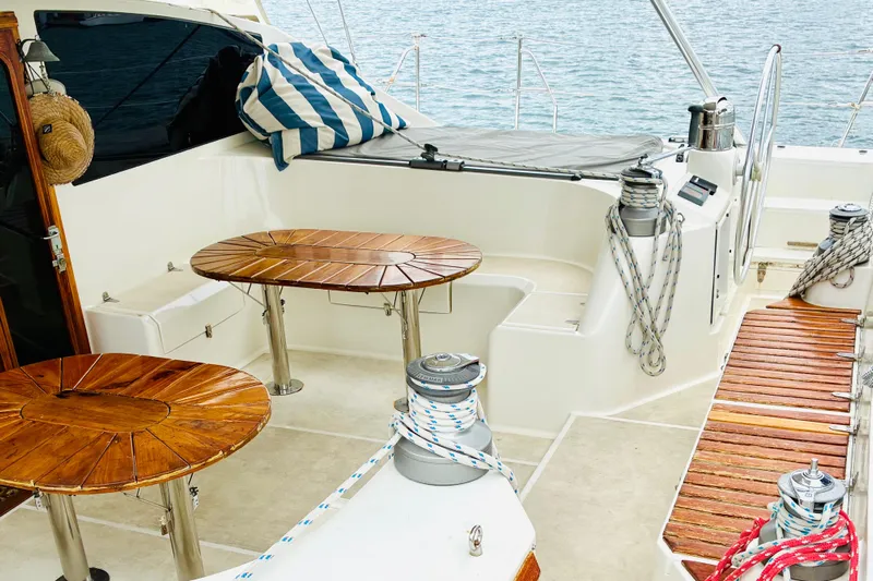 Scout Yacht Photos Pics Luxurious 1992 Privilege 482 yacht deck with wooden tables and nautical ropes.