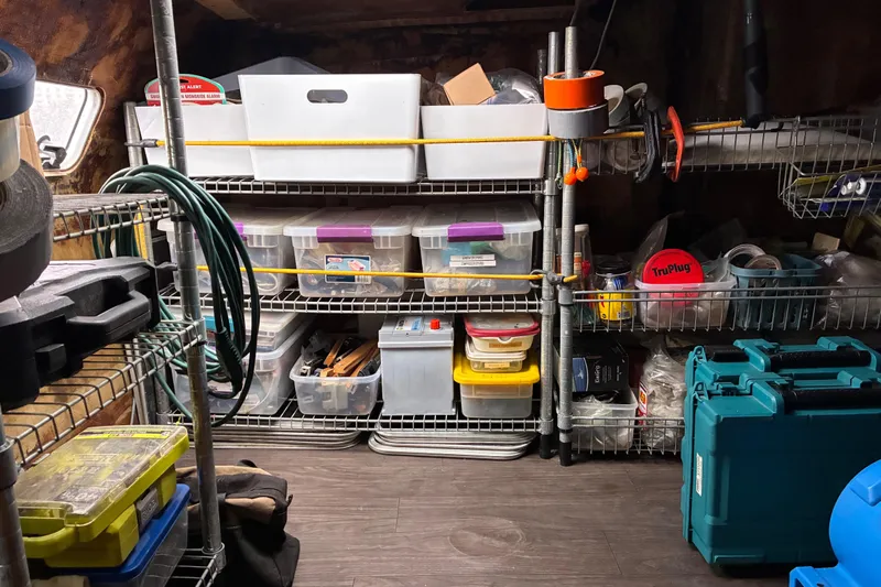 Scout Yacht Photos Pics Organized storage shelves with various tools and containers on a Privilege 482, 1992 model.