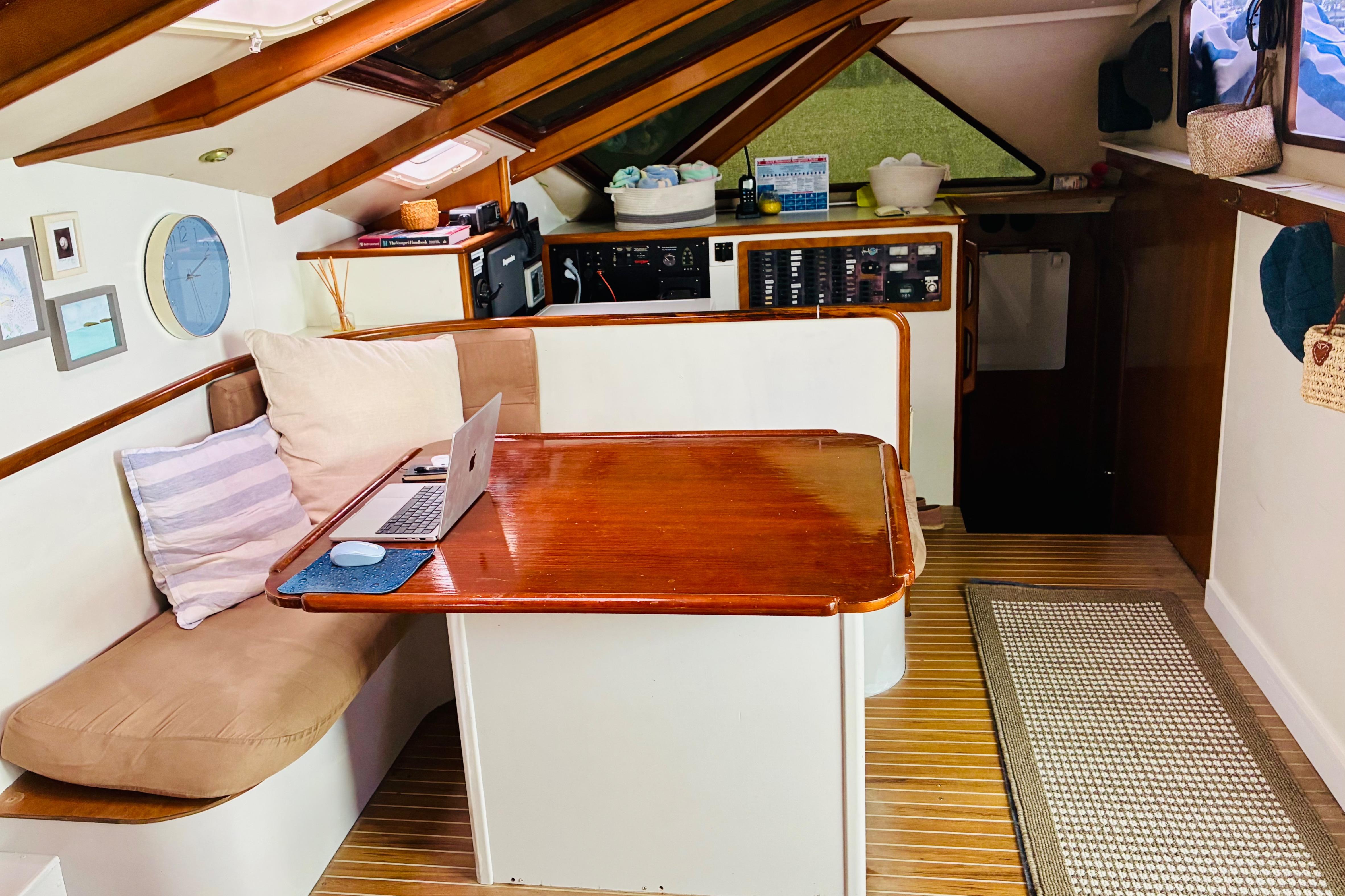 Cozy interior of 1992 Privilege 482 yacht with wooden table and seating area.
