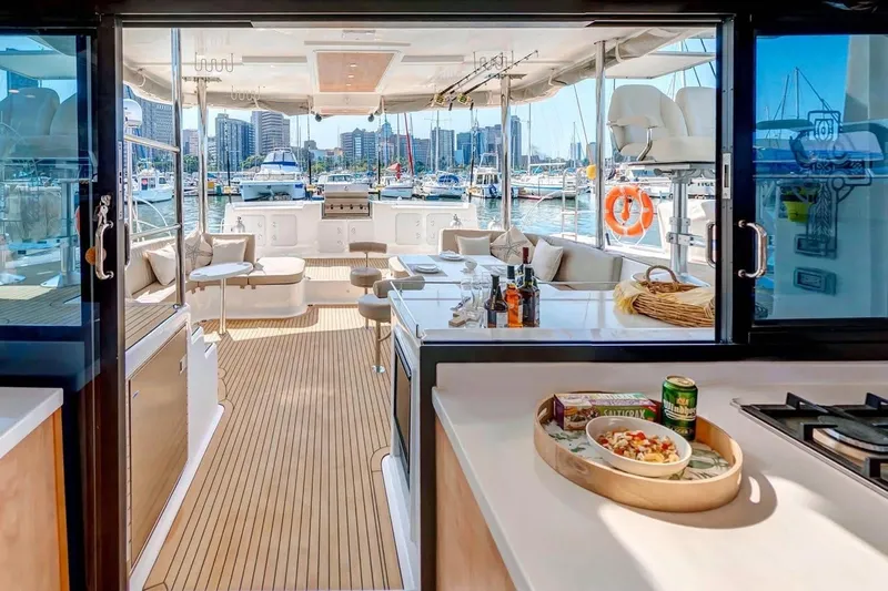 Lost Abbey Yacht Photos Pics Luxurious 2021 Royal Cape Catamarans Majestic yacht interior with marina view.