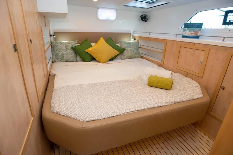 Lost Abbey Yacht Photos Pics Luxurious cabin interior of 2021 Royal Cape Catamarans Majestic with cozy bedding and modern design.