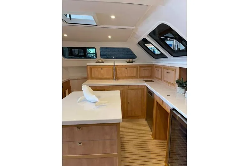 Lost Abbey Yacht Photos Pics Luxurious 2021 Royal Cape Catamarans Majestic kitchen with modern wood cabinetry and sleek countertops.